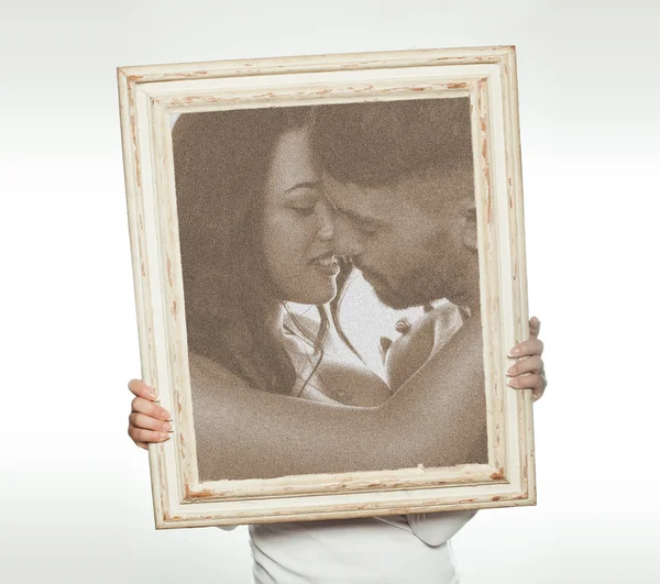 Woman holding a romantic picture — Stock Photo, Image