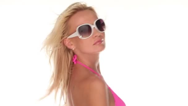 Aantrekkelijke jonge vrouw dansen in roze bikini op witte achtergrond — Stockvideo