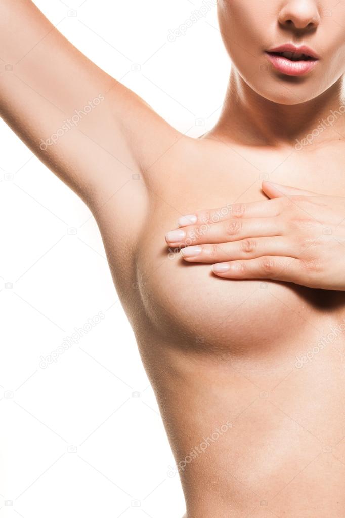 Naked woman checking fro breast cancer