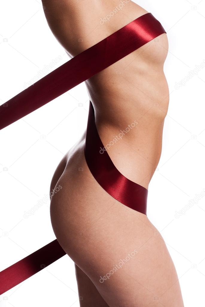 Red ribbon wound around a naked female body