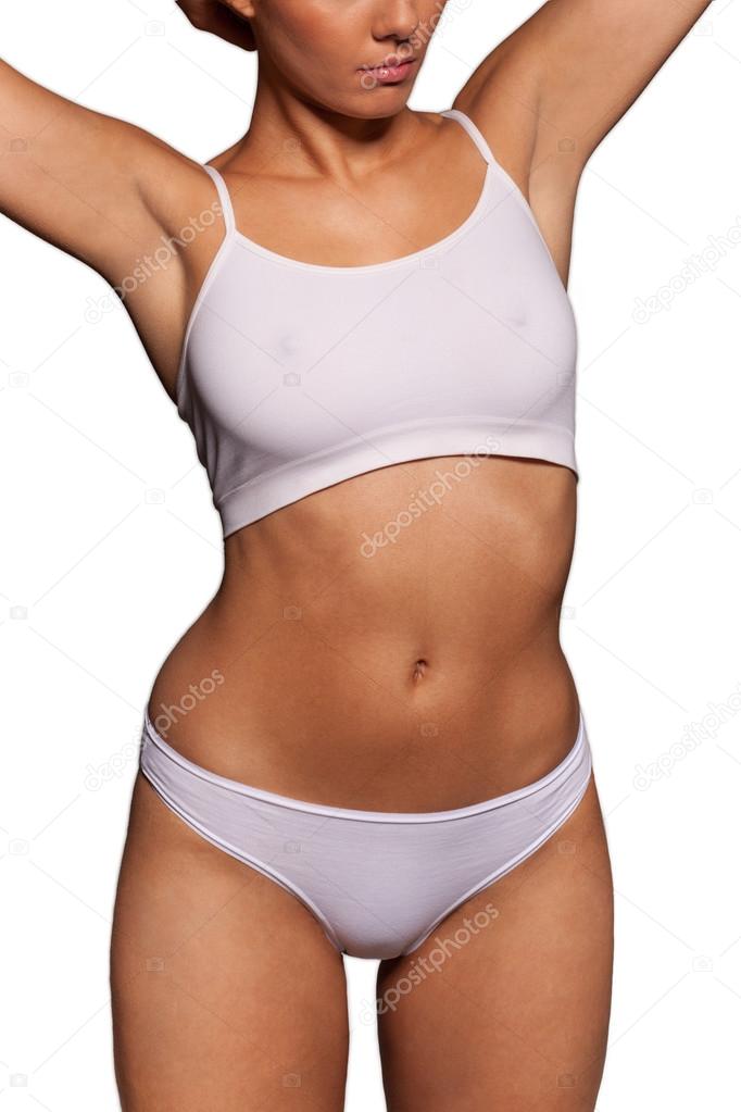 Athletic woman in a sports bra and panties Stock Photo by