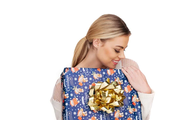 Woman holds a gift wrapped in christmas paper — Stock Photo, Image