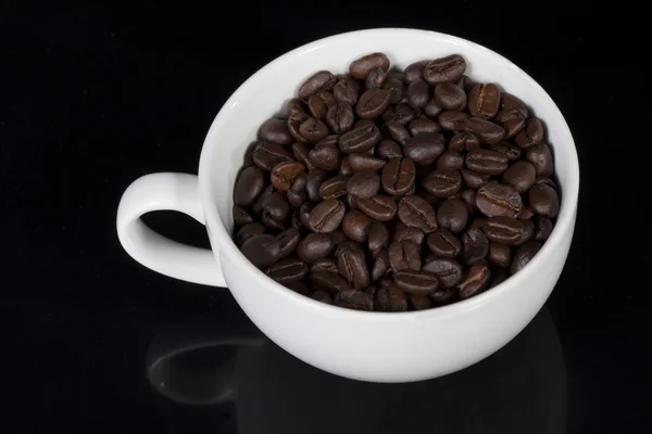 Tasse voll geröstete Kaffeebohnen — Stockfoto