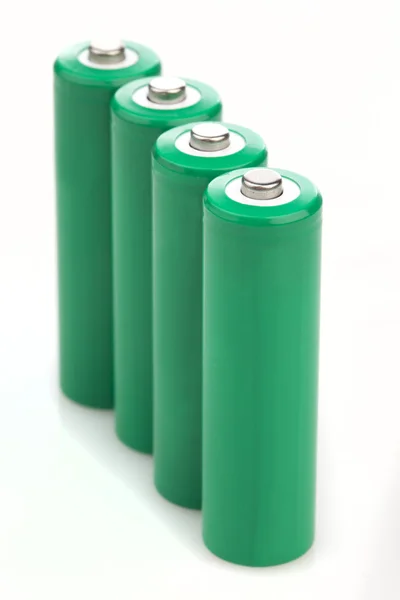 Four green batteries with blank covers — Stock Photo, Image