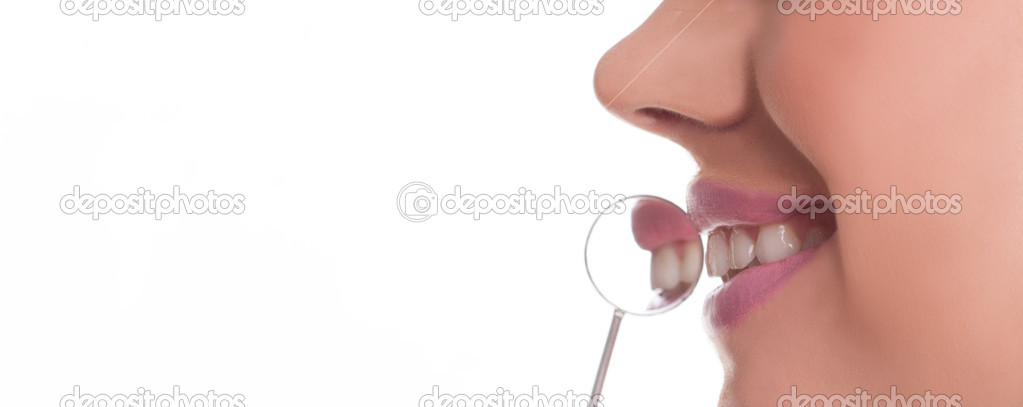 Smiling woman with a dental mirror