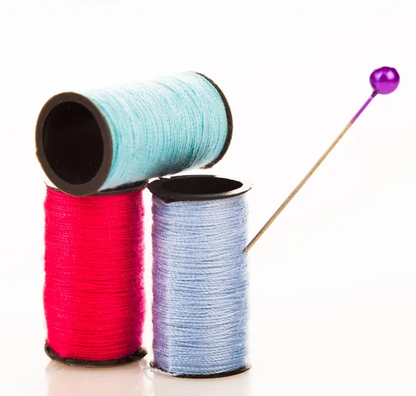 Three reels of cotton with a pin — Stock Photo, Image