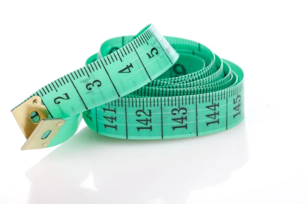 Green measuring tape, symbol of accuracy, on white — Stock Photo, Image