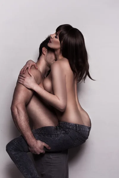 Jovem casal topless abraçando em jeans — Fotografia de Stock