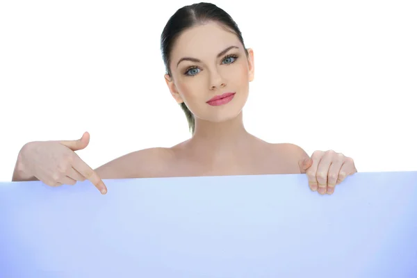 Beautiful woman pointing to a blank sign — Stock Photo, Image