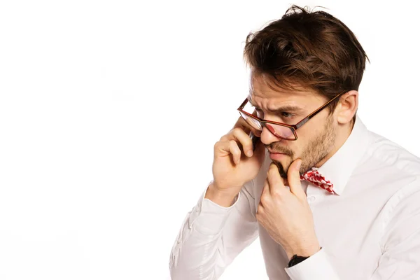 Nerdy businessman talking on a smartphone — Stock Photo, Image