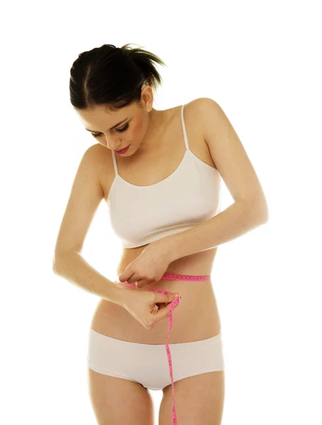 Slim woman measuring her waistline — Stock Photo, Image