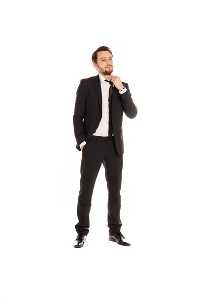 Young businessman standing adjusting his tie — Stock Photo, Image