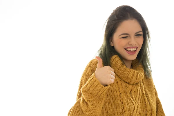 Enthusiastic woman winking and giving a thumbs up — Stock Photo, Image