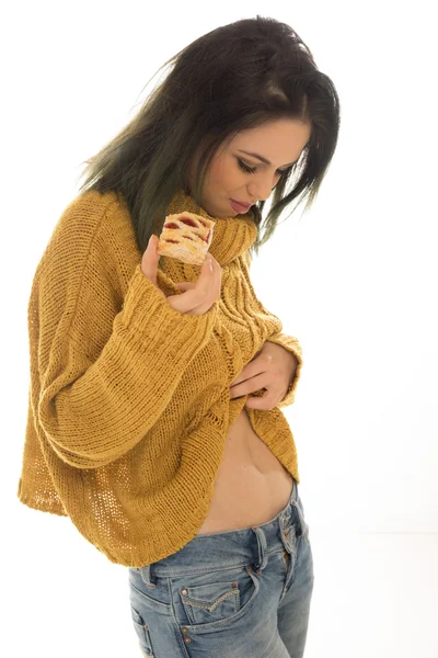 Slim woman eating a cake, on white background — Stock Photo, Image