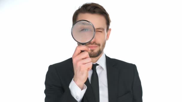 Businessman looking through a magnifying glass — Stock Video