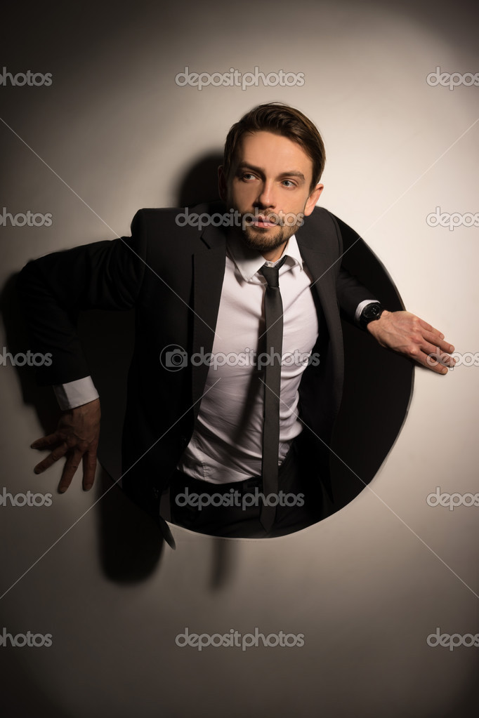 Businessman Climbing Out Of A Circular Hole Stock Image Businessman Climbing Out Of A Circular Hole Stock Image