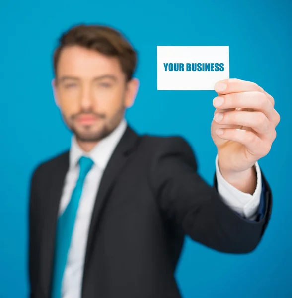 Guapo hombre de negocios mostrando tarjeta de visita en blanco — Foto de Stock