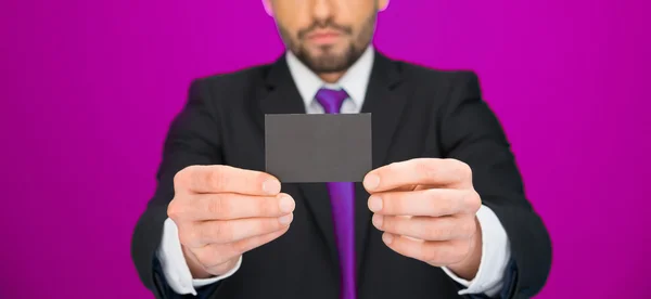 Handsome businessman showing blank business card — Stock Photo, Image