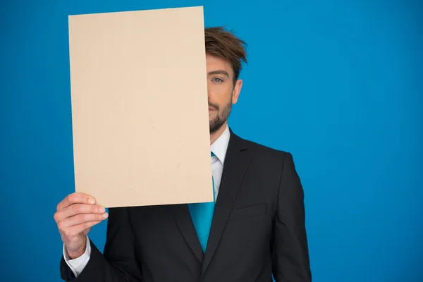 Businessman holding blank poster — Stock Photo, Image