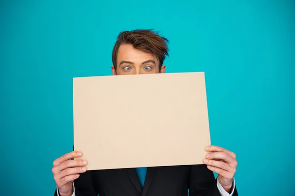 Businessman holding blank poster — Stock Photo, Image