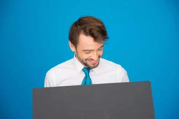 Businessman holding blank poster — Stock Photo, Image