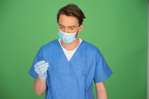 Mannelijke arts of verpleegkundige kijken naar zijn gehandschoende hand — Stok fotoğraf