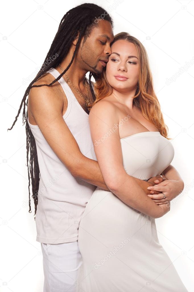 Beautiful mixed couple in loving embrace