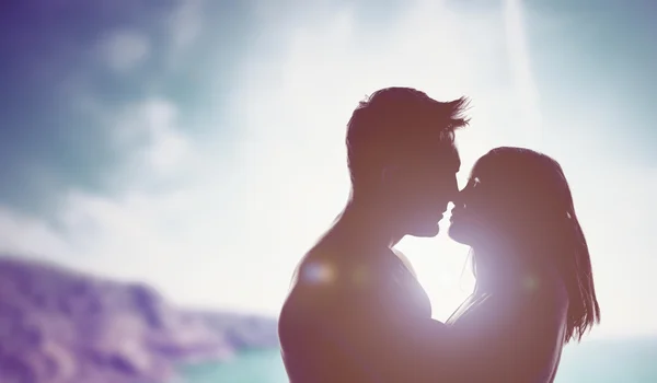 Loving couple backlit by a bright sun — Stock Photo, Image