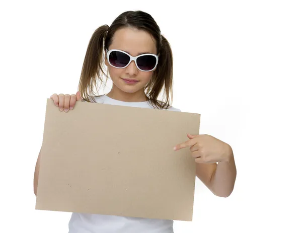 Chica joven de moda apuntando a una tarjeta en blanco — Foto de Stock