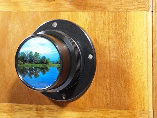 Old camera lens with picturesque landscape. — Stock Photo, Image