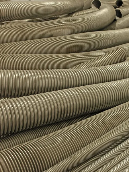 Various flexible metal hose in a warehouse. — Stock Photo, Image