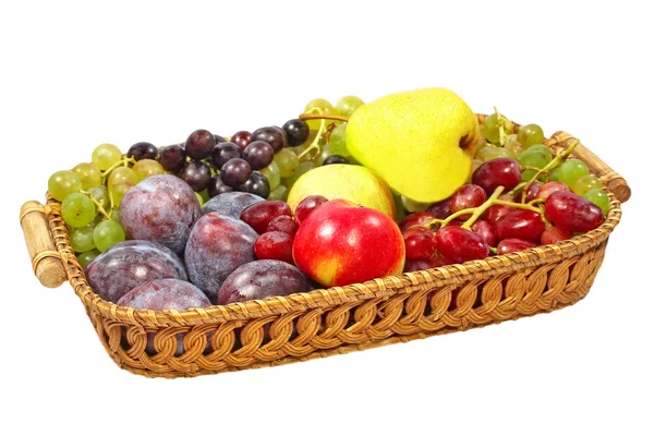 Fresh fruits on a straw pot.Isolated. — Stock Photo, Image