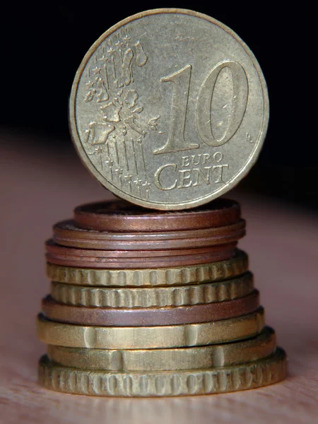 Ten euro cent coin balancing on a top of coins pile. — Stock Photo, Image