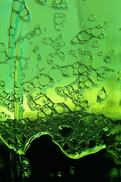 Kall öl skum på gröna flaskan tagit closeup.background. — Stockfoto