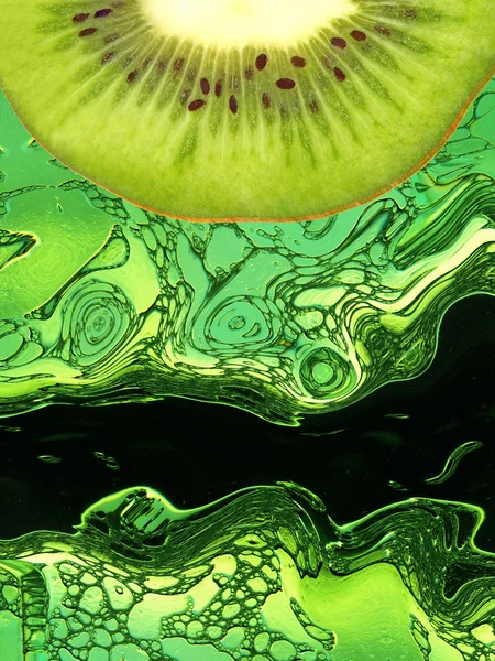 Kiwi slice taken closeup on green abstract background. — Stok Foto