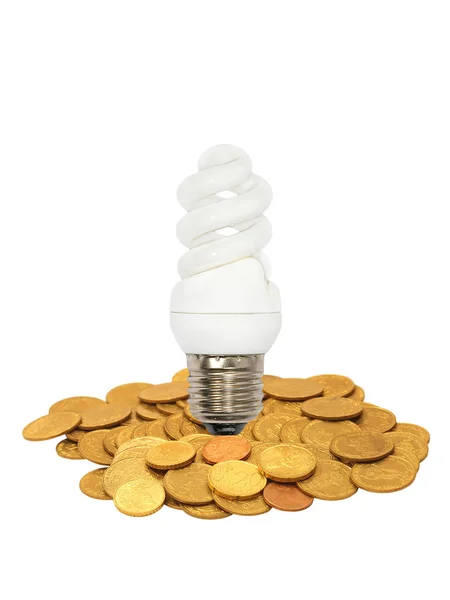 Energy save lamp on coins heap.Isolated. — Stock Photo, Image