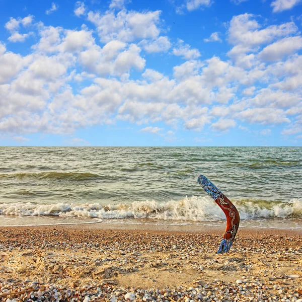 Multicolored Australian Boomerang Sandy Beach Sea Surf Cloudy Sky — Stock Photo, Image