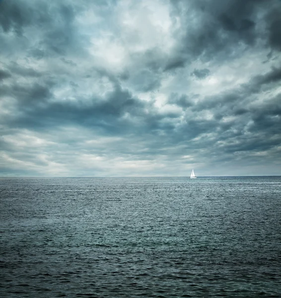 Sailing Boat at Stormy Sea. Dark Background. Royalty Free Stock Images