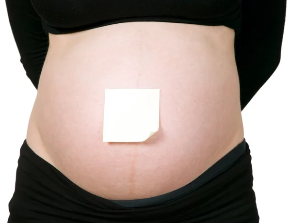 Kleverige papier op baby bump — Stockfoto