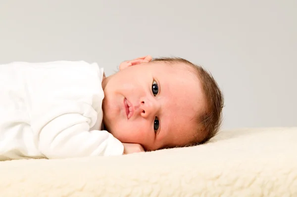 Baby boy with white shirts is lying — Stock Photo, Image