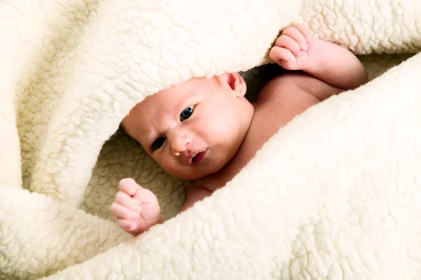 Baby boy is lying under blanket — Stock Photo, Image