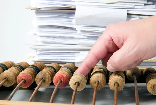 Mathematical calculator abacus with papers — Stock Photo, Image