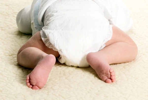 Baby boy is lying with diapers — Stock Photo, Image