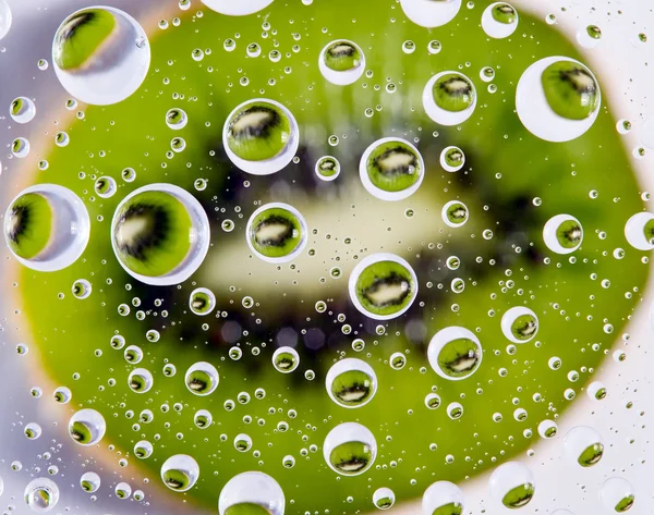 Green kiwi background with water drops