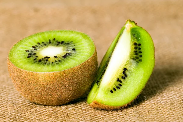 Green fruit kiwi on brown background — Stock Photo, Image