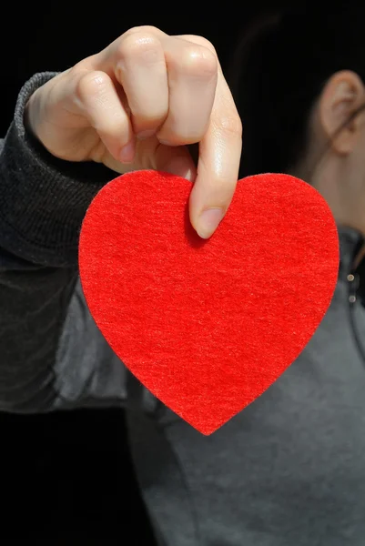 Girl with a red heart — Stock Photo, Image