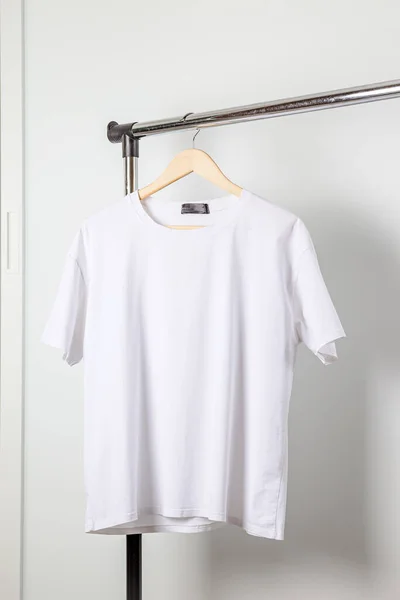 White t-shirt mockup on clothes hanger. Bella canvas mock up in minimal style. — Stock Photo, Image
