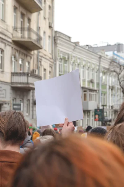 Woman holding poster in her hand against background of feminist protest — Stock Photo, Image