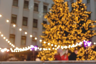 Yılbaşı süsündeki Noel ağaçları çok katlı binanın arka planında. Bulanık görüntü. Duvar Kağıdı