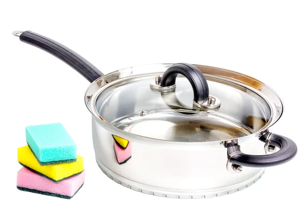 Stainless steel deep stewing pan with sponges on white background — Stock Photo, Image